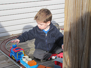This young man figured out quickly how to control the Playskool train by pushing the button on the smokestack. Click for bigger photo.
