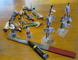 Inexpensive plastic figures ordered in bulk from China, being glued to PETE bases.  Click for bigger photo.