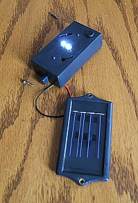 This photo shows the top of the solar cell and the LEDs.  They are glowing because it's dark enough in my kitchen to set it off. They are bright, because the device has been charging for days while turned off, so it couldn't discharge.