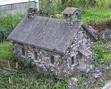 This stone cottage seems to have been framed in concrete, then had a veneer of small stones applied. Click for bigger photo.