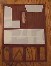 This photo shows a wall piece with one corner 'started,' and several corners finished by overlapping bits of tape with obtuse angles. Click for bigger photo.