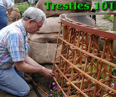 A member of the Columbus Garden Railway Society helps with the finishing touches on a trestle at the Franklin Park conservatory. Click for a bigger picture.