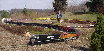 Here on Bob Fletcher's railroad, the train has already looped over itself at about the 40th car.  A second train is next to this one on the other track, giving the illusion of a much longer train. Click for bigger photo.