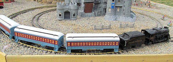 The G-gauge Lionel Polar Express battery-powered train with an extra coach running on a special display on our garden railroad in November, 2019.  Click for bigger photo.